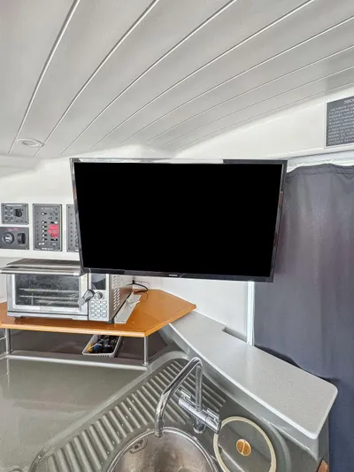 Knot Stupid Yacht Photos Pics Interior of 2005 Fountaine Pajot HIGHLAND with modern kitchen appliances and sleek design.