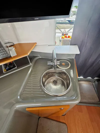 Knot Stupid Yacht Photos Pics Compact kitchen sink area on 2005 Fountaine Pajot HIGHLAND yacht with modern fixtures.