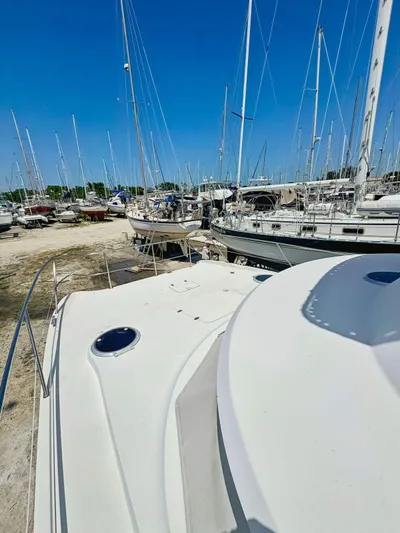 Knot Stupid Yacht Photos Pics 2005 Fountaine Pajot HIGHLAND yacht on land, surrounded by other boats under clear blue sky.