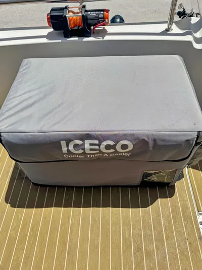 Knot Stupid Yacht Photos Pics ICECO cooler on 2005 Fountaine Pajot HIGHLAND boat deck, with safety equipment nearby.