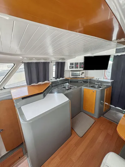 Knot Stupid Yacht Photos Pics Interior of 2005 Fountaine Pajot HIGHLAND yacht with modern kitchen and wood accents.