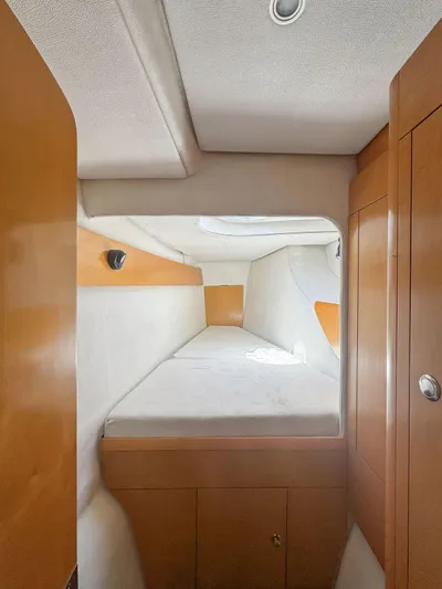 Knot Stupid Yacht Photos Pics 2005 Fountaine Pajot HIGHLAND cabin interior with wooden finish and cozy bed.