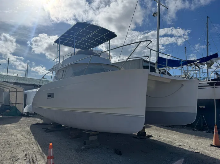 Knot Stupid Yacht Photos Pics 2005 Fountaine Pajot HIGHLAND catamaran on dry dock under a sunny sky.