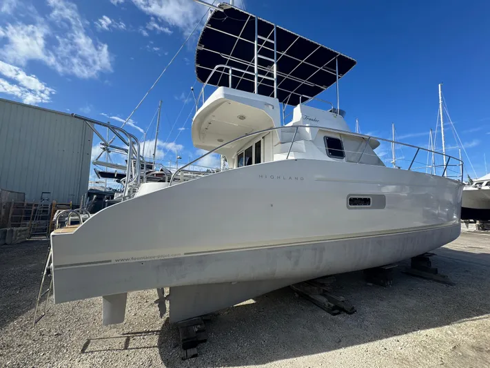 Knot Stupid Yacht Photos Pics 2005 Fountaine Pajot HIGHLAND yacht on dry dock under clear blue sky.