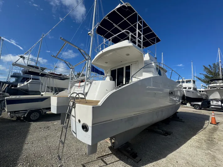 Knot Stupid Yacht Photos Pics 2005 Fountaine Pajot HIGHLAND yacht on dry dock under clear blue sky.