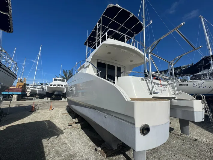Knot Stupid Yacht Photos Pics 2005 Fountaine Pajot HIGHLAND catamaran on dry dock under clear blue sky.