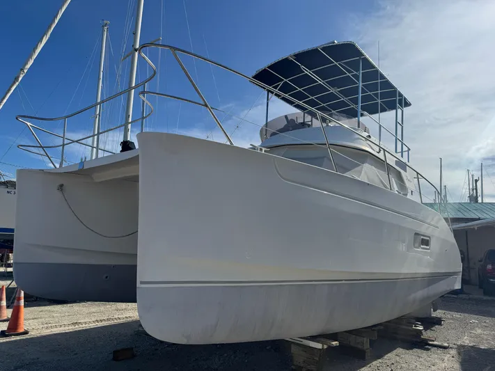 Knot Stupid Yacht Photos Pics 2005 Fountaine Pajot HIGHLAND catamaran on dry dock under clear blue sky.