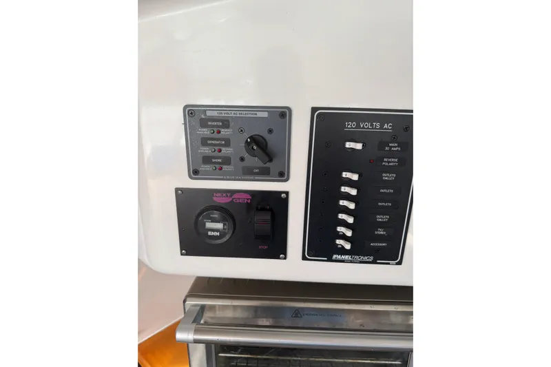 Knot Stupid Yacht Photos Pics Control panel of a 2005 Fountaine Pajot HIGHLAND boat, featuring electrical switches and generator controls.