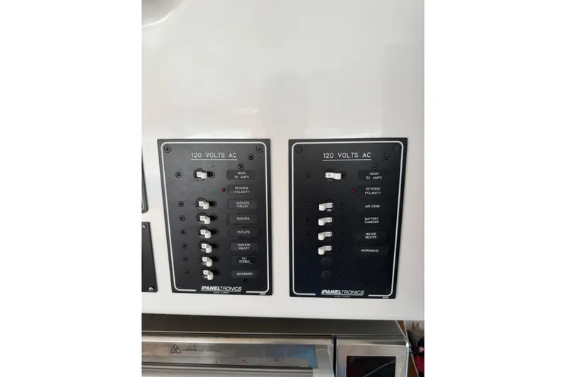 Knot Stupid Yacht Photos Pics Electrical panel on a 2005 Fountaine Pajot HIGHLAND boat, featuring 120 volts AC switches.