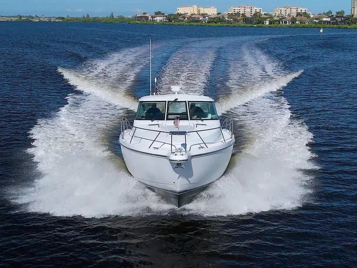 The Adventure Yacht Photos Pics 2008 Tiara Yachts 4300 Sovran cruising on open water, creating a dynamic wake.