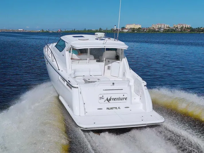 The Adventure Yacht Photos Pics 2008 Tiara Yachts 4300 Sovran cruising on a calm waterway.
