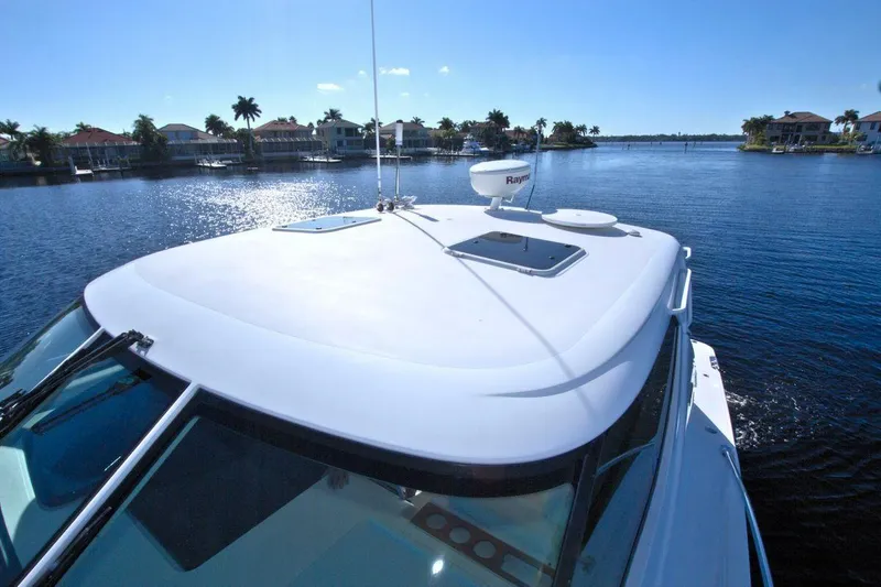 The Adventure Yacht Photos Pics 2008 Tiara Yachts 4300 Sovran cruising on a sunny day, showcasing sleek design and waterfront view.