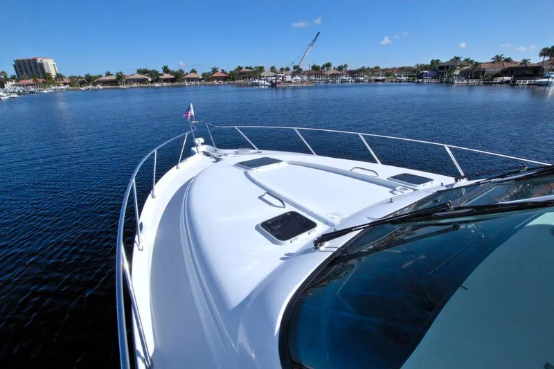 The Adventure Yacht Photos Pics 2008 Tiara Yachts 4300 Sovran on calm water, scenic marina view.