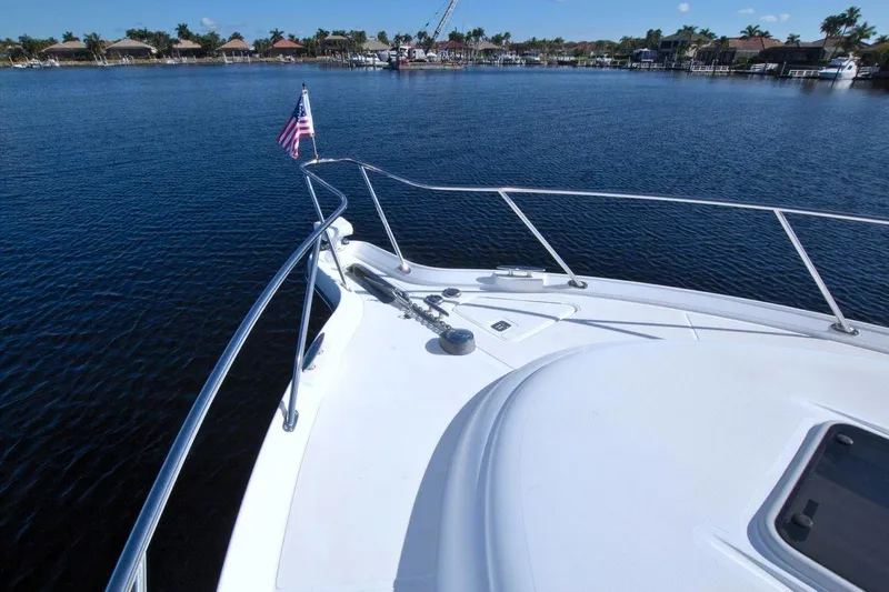 The Adventure Yacht Photos Pics 2008 Tiara Yachts 4300 Sovran on calm water with American flag.