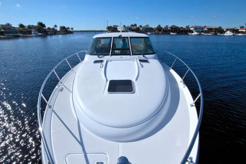 The Adventure Yacht Photos Pics 2008 Tiara Yachts 4300 Sovran on calm water, showcasing sleek design and spacious deck.