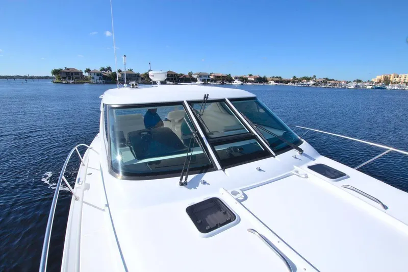 The Adventure Yacht Photos Pics 2008 Tiara Yachts 4300 Sovran on calm water, showcasing sleek design and spacious deck.
