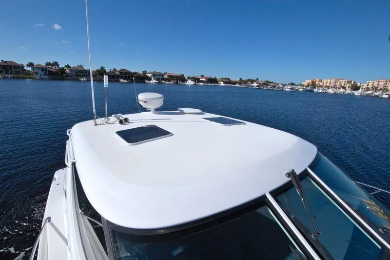 The Adventure Yacht Photos Pics 2008 Tiara Yachts 4300 Sovran on calm water, showcasing sleek design and spacious deck.