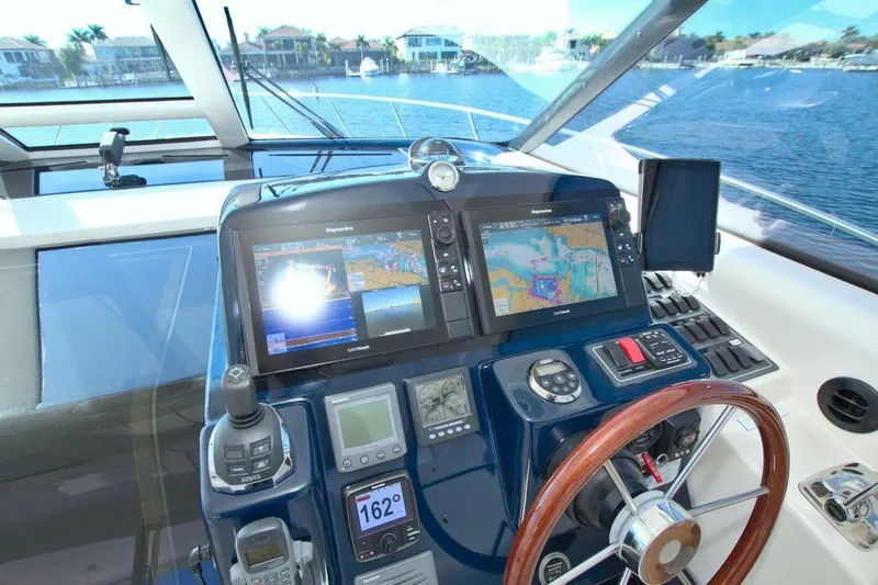 The Adventure Yacht Photos Pics 2008 Tiara Yachts 4300 Sovran helm with navigation screens and steering wheel.