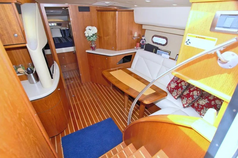 The Adventure Yacht Photos Pics Luxurious interior of 2008 Tiara Yachts 4300 Sovran with wood finishes and cozy seating.