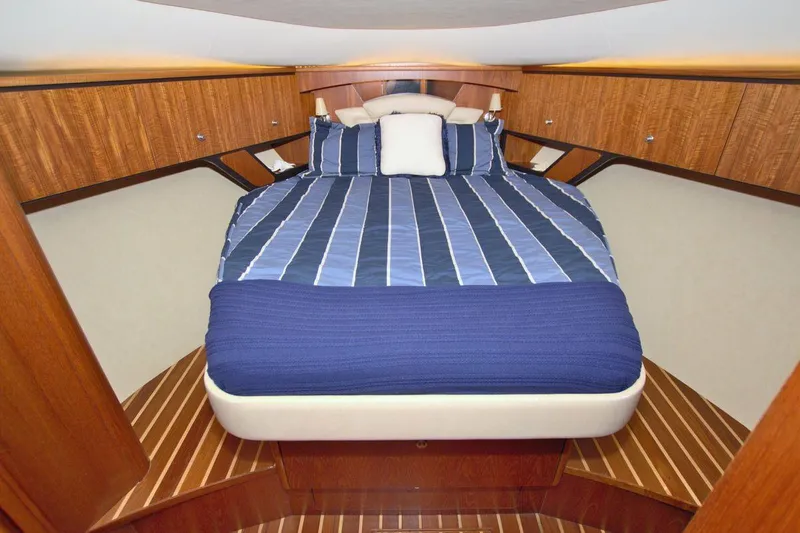 The Adventure Yacht Photos Pics Luxurious cabin interior of 2008 Tiara Yachts 4300 Sovran with striped bedding.