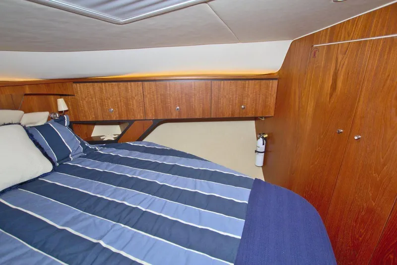 The Adventure Yacht Photos Pics Luxurious cabin interior of 2008 Tiara Yachts 4300 Sovran with striped bedding.