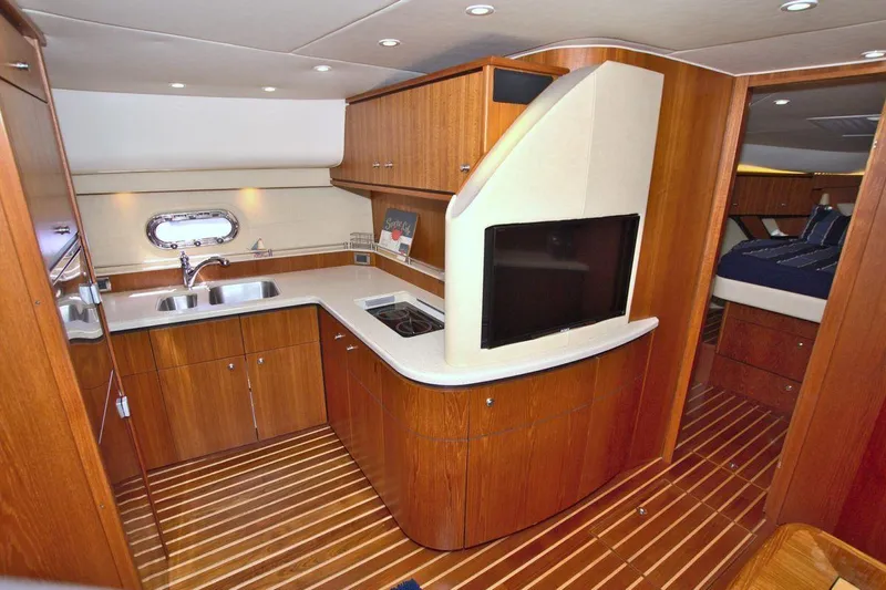 The Adventure Yacht Photos Pics 2008 Tiara Yachts 4300 Sovran interior with wood cabinetry and modern kitchen amenities.