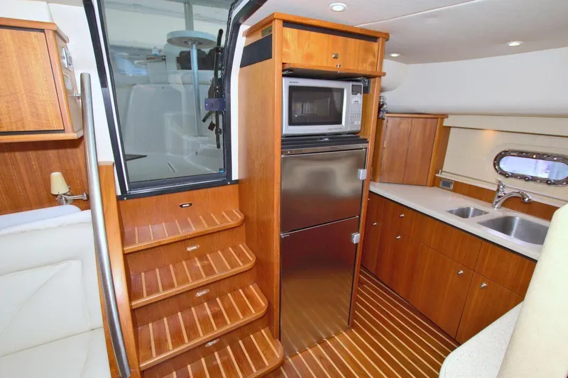 The Adventure Yacht Photos Pics Interior of 2008 Tiara Yachts 4300 Sovran with wood cabinetry and modern appliances.