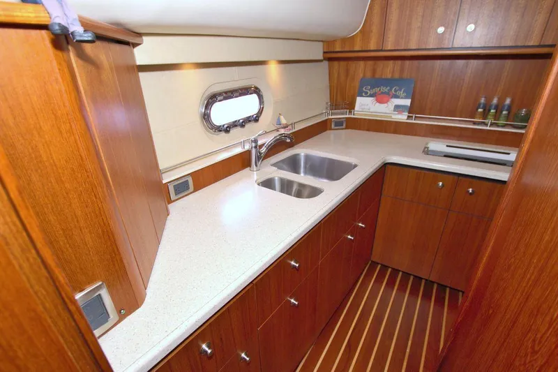 The Adventure Yacht Photos Pics Luxurious 2008 Tiara Yachts 4300 Sovran galley with wood cabinetry and dual sinks.