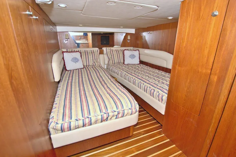The Adventure Yacht Photos Pics 2008 Tiara Yachts 4300 Sovran cabin with twin beds and striped bedding.