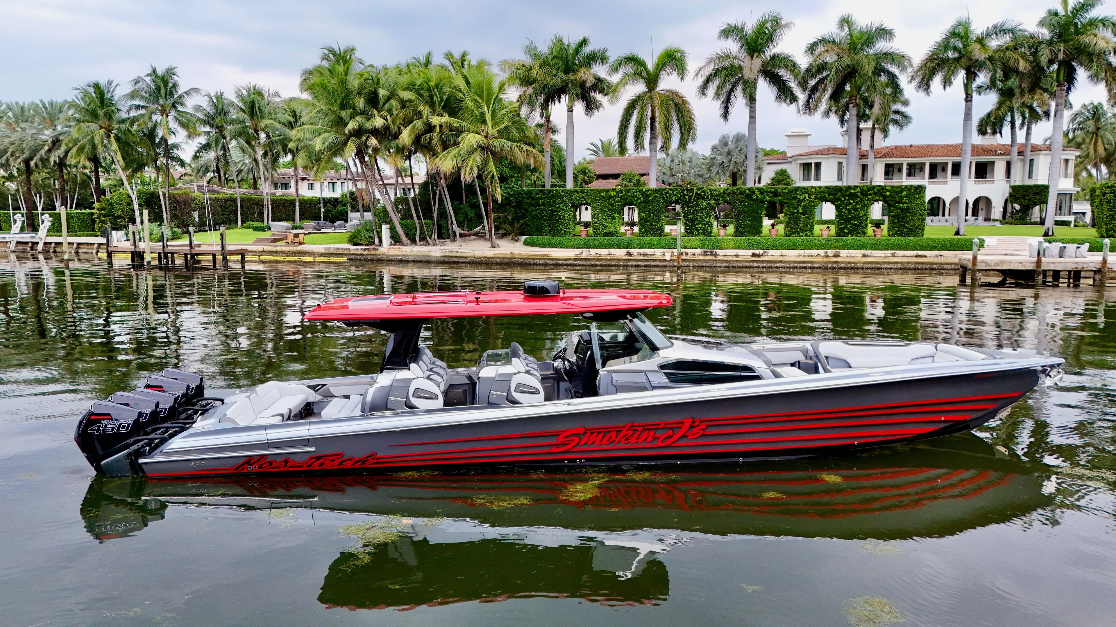  Yacht Photos Pics 2022 Nor-Tech 50 Sport boat on a scenic waterfront with palm trees.