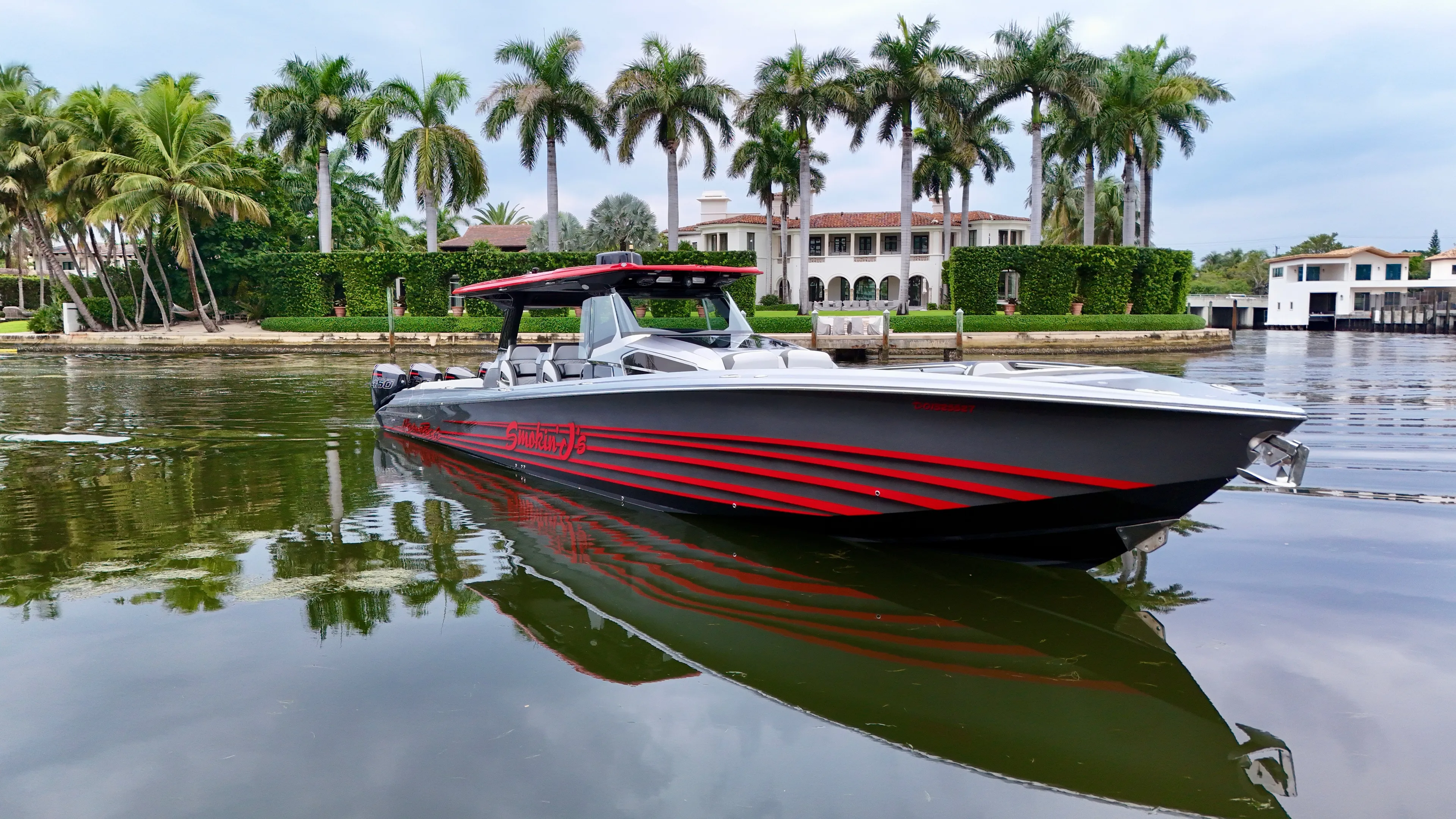 Yacht Photos Pics 2022 Nor-Tech 50 Sport boat on calm water, surrounded by palm trees and luxury homes.
