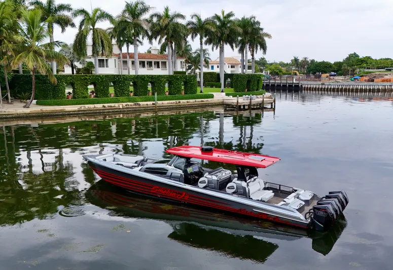  Yacht Photos Pics 2022 Nor-Tech 50 Sport boat on calm water near luxury waterfront homes.