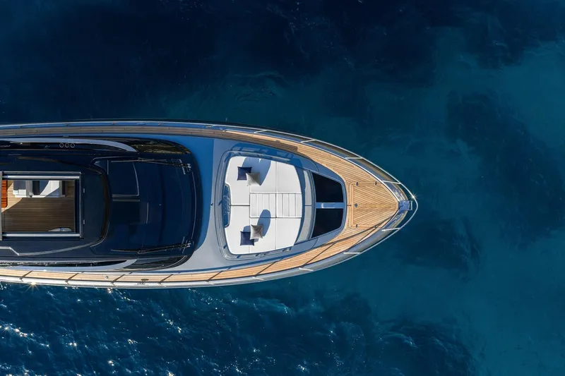  Yacht Photos Pics Aerial view of 2025 Riva Capri 58 yacht on clear blue water.
