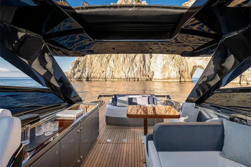  Yacht Photos Pics Luxurious 2025 Riva Capri 58 yacht interior with scenic ocean and rock formation view.