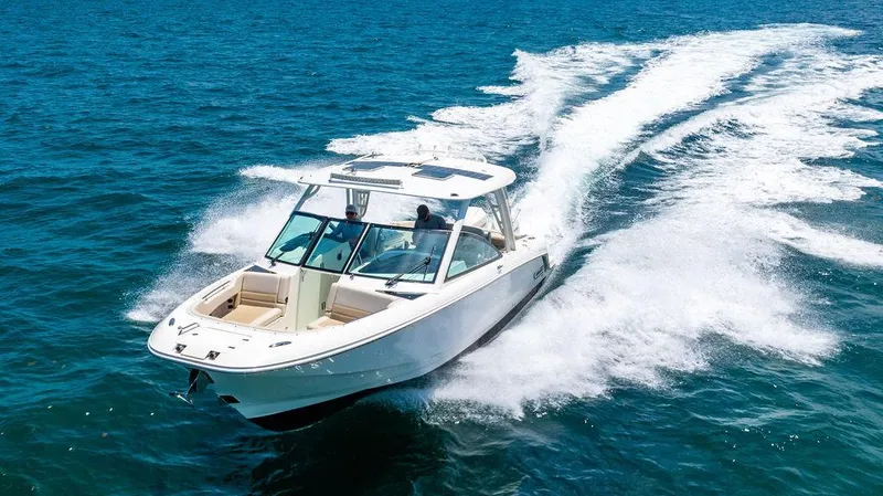  Yacht Photos Pics 2019 Boston Whaler 320 Vantage cruising on open water, showcasing sleek design and performance.