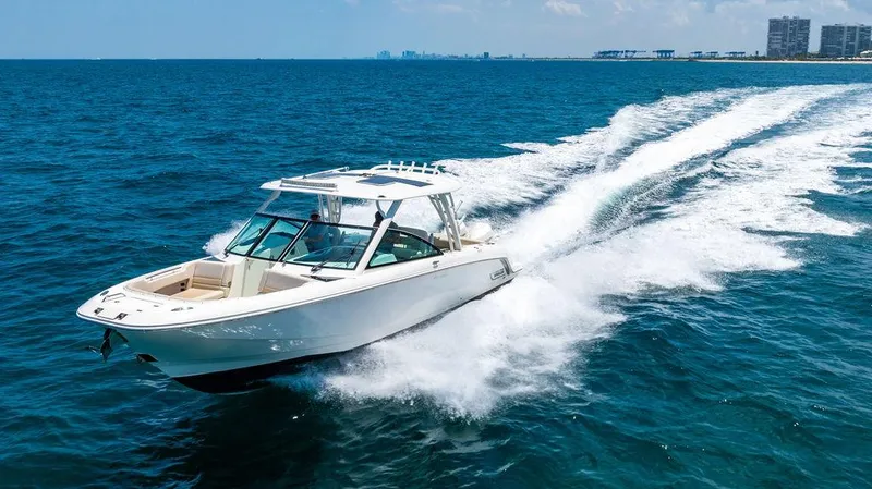  Yacht Photos Pics 2019 Boston Whaler 320 Vantage cruising on open blue ocean waters.