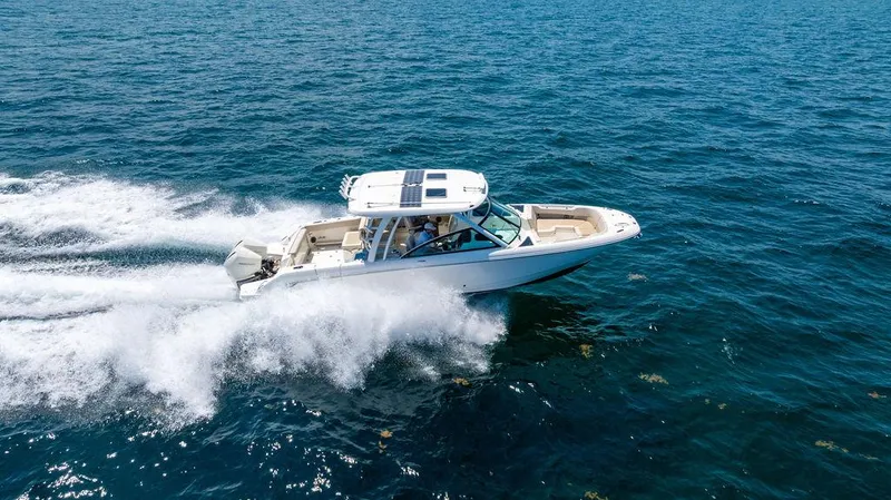  Yacht Photos Pics 2019 Boston Whaler 320 Vantage cruising on open water, showcasing speed and elegance.