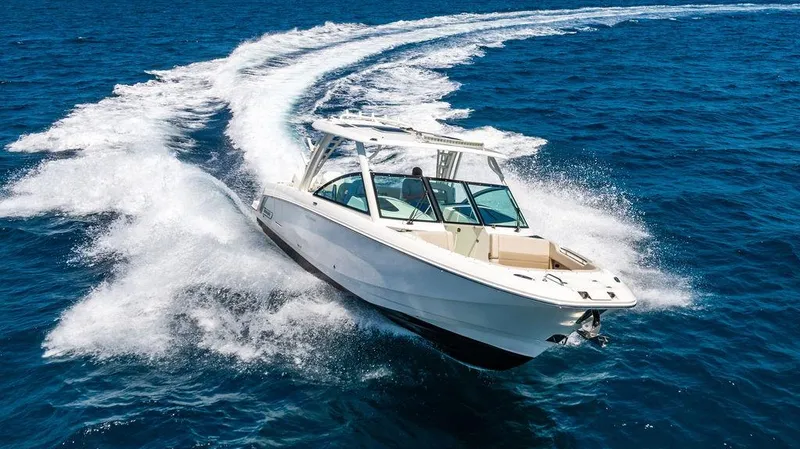  Yacht Photos Pics 2019 Boston Whaler 320 Vantage cruising on open blue water, creating a dynamic wake.