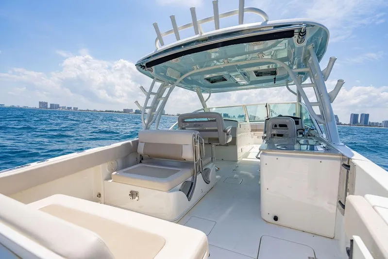  Yacht Photos Pics 2019 Boston Whaler 320 Vantage boat on open water, showcasing spacious deck and seating.