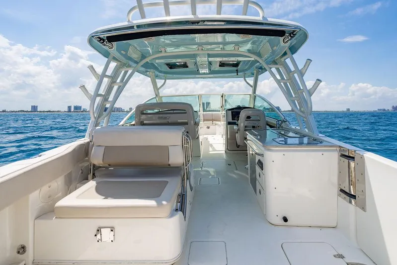  Yacht Photos Pics 2019 Boston Whaler 320 Vantage boat interior on open water, showcasing seating and helm.