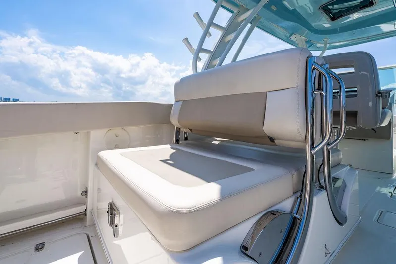  Yacht Photos Pics 2019 Boston Whaler 320 Vantage boat interior with cushioned seating and sleek design.