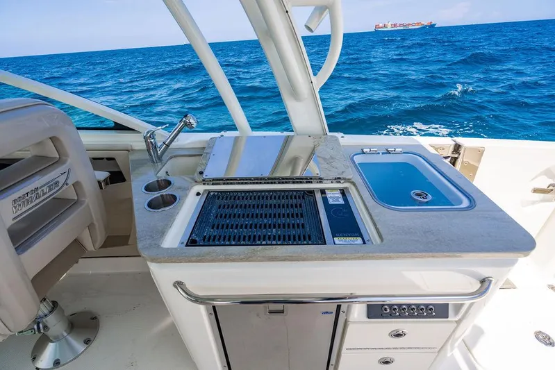  Yacht Photos Pics Boston Whaler 320 Vantage 2019 boat kitchen with grill and sink, ocean view.