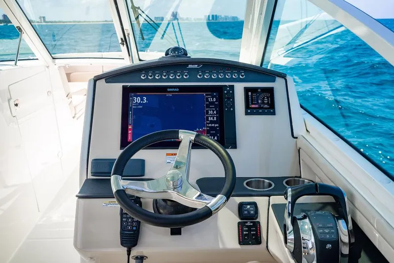  Yacht Photos Pics 2019 Boston Whaler 320 Vantage helm with navigation display and steering wheel on open water.