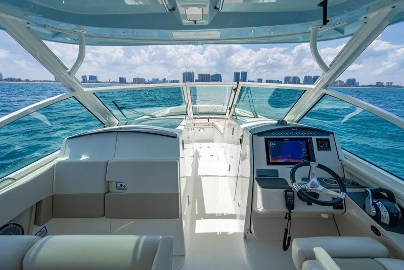  Yacht Photos Pics 2019 Boston Whaler 320 Vantage boat interior with ocean view and modern dashboard.