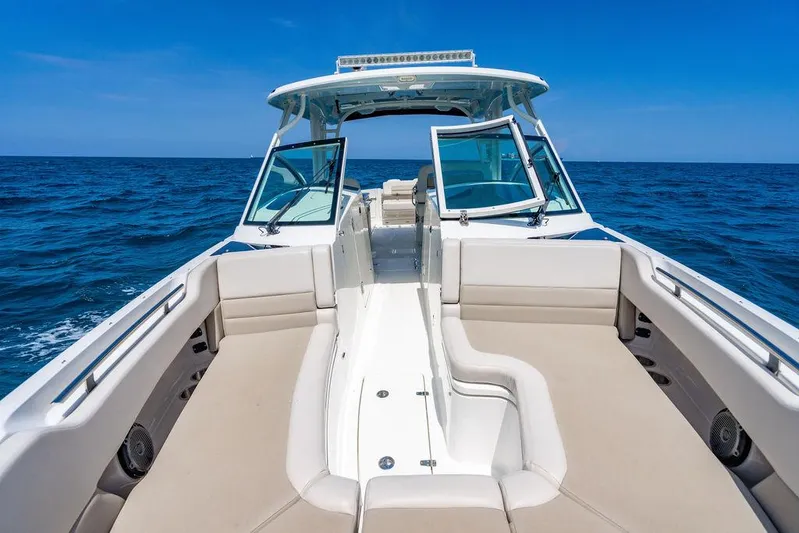  Yacht Photos Pics 2019 Boston Whaler 320 Vantage boat on open sea, featuring spacious seating and sleek design.