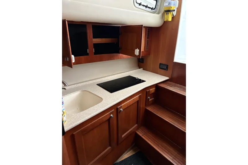  Yacht Photos Pics 2006 Rampage 38 Express yacht kitchen with wooden cabinets and countertop.