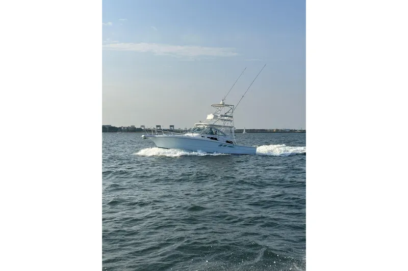  Yacht Photos Pics 2006 Rampage 38 Express boat cruising on open water under clear skies.
