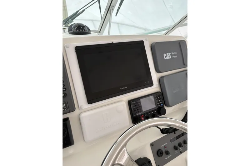  Yacht Photos Pics 2006 Rampage 38 Express helm with Garmin display and CAT Marine Power panel.