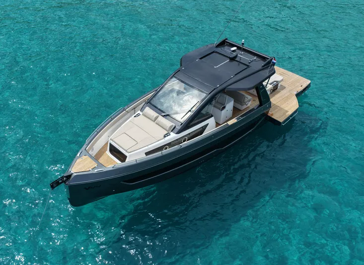  Yacht Photos Pics 2025 Schaefer V44 yacht on clear turquoise water, showcasing sleek design and luxury features.