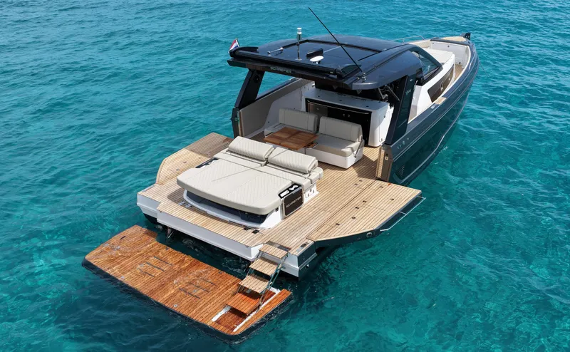  Yacht Photos Pics 2025 Schaefer V44 yacht on clear blue water, featuring spacious deck and modern design.